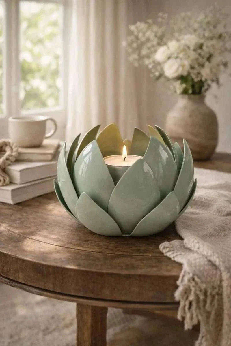 Green metal leaf candle holder with decorative glass hurricane for elegant home décor and ambient lighting