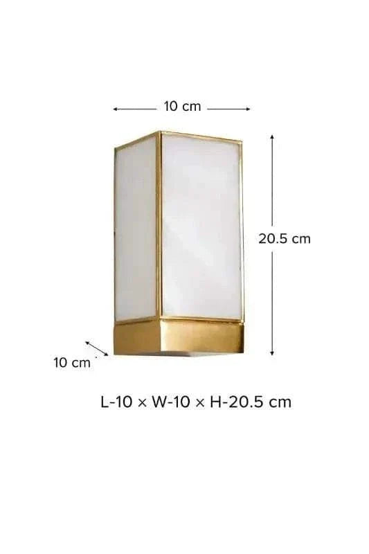 Modern rectangular glass wall lamp with milky white glass and antique brass finish providing soft ambient lighting