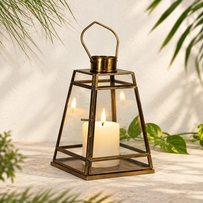 Vintage Antique Brass Glass Lantern by ILLUMEA with a tapered geometric body and loop handle, designed to complement luxury home décor, festive styling and hospitality spaces.