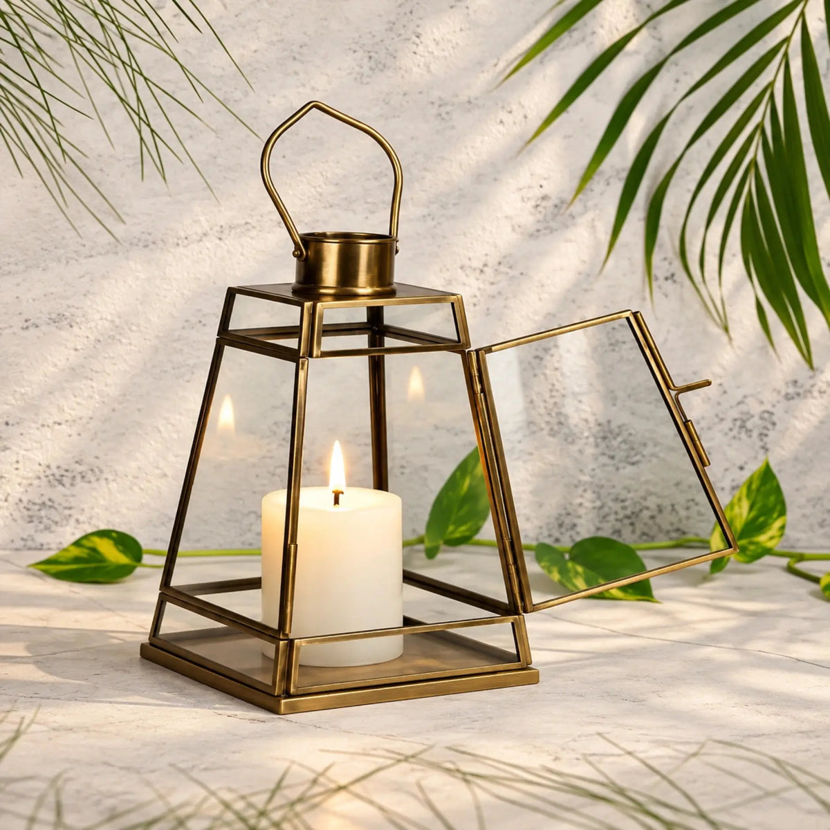 ILLUMEA Luxury Glass Hanging Lantern with Antique Brass Finish, featuring a structured geometric design and clear glass enclosure for elegant candlelight or decorative lighting.