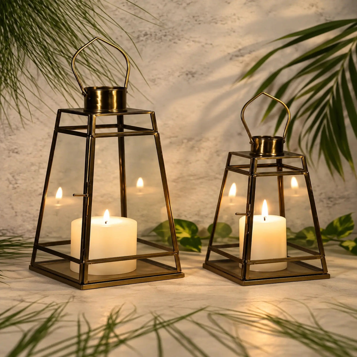 ILLUMEA Geometric Antique Glass Lantern featuring a tapered square frame, brass finish and clear glass panels, ideal for premium residential and hospitality décor.