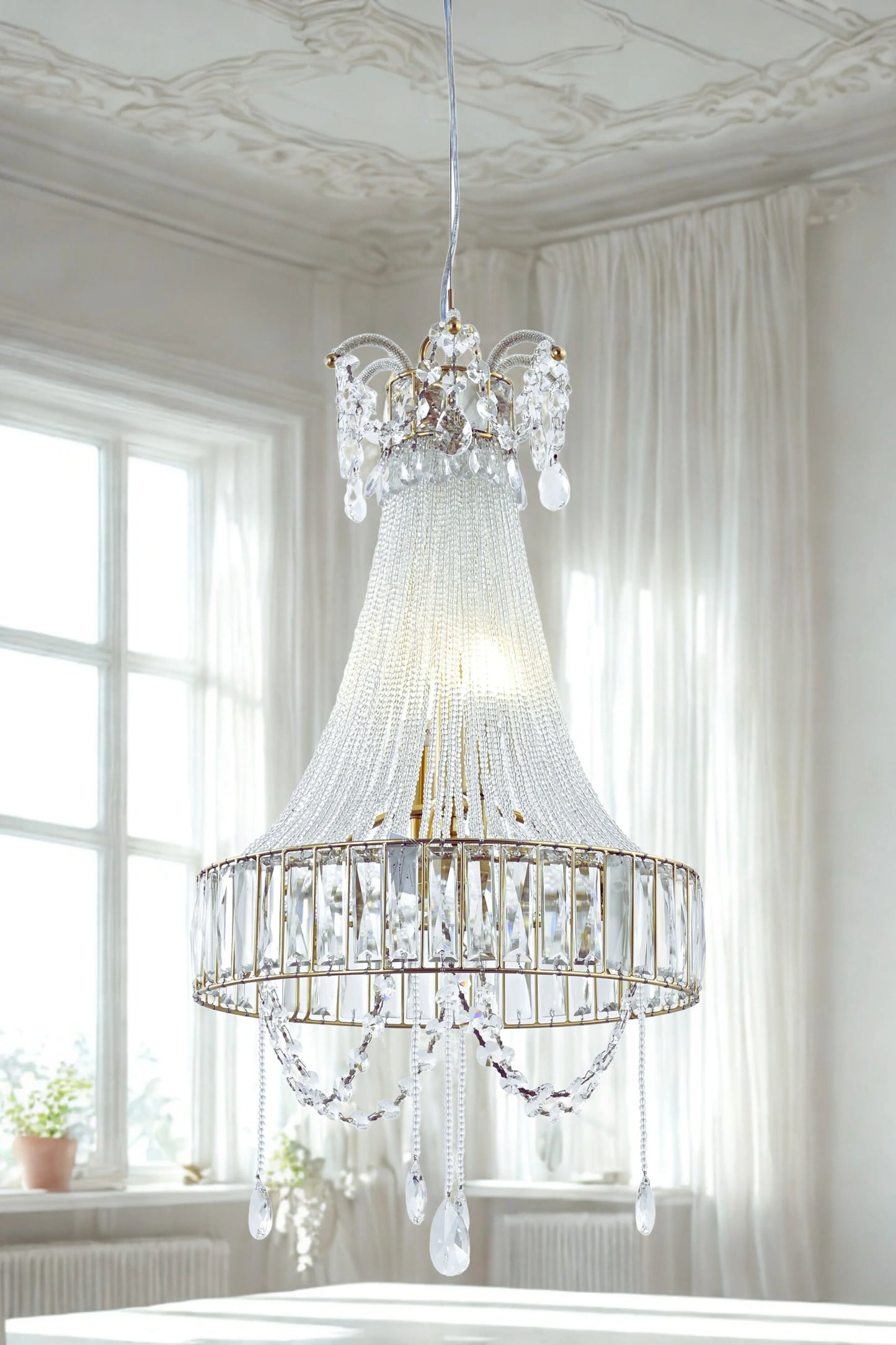 A luxurious crystal glass chandelier with a fluted glass body and hanging crystal beads, displayed in a bright room setting.