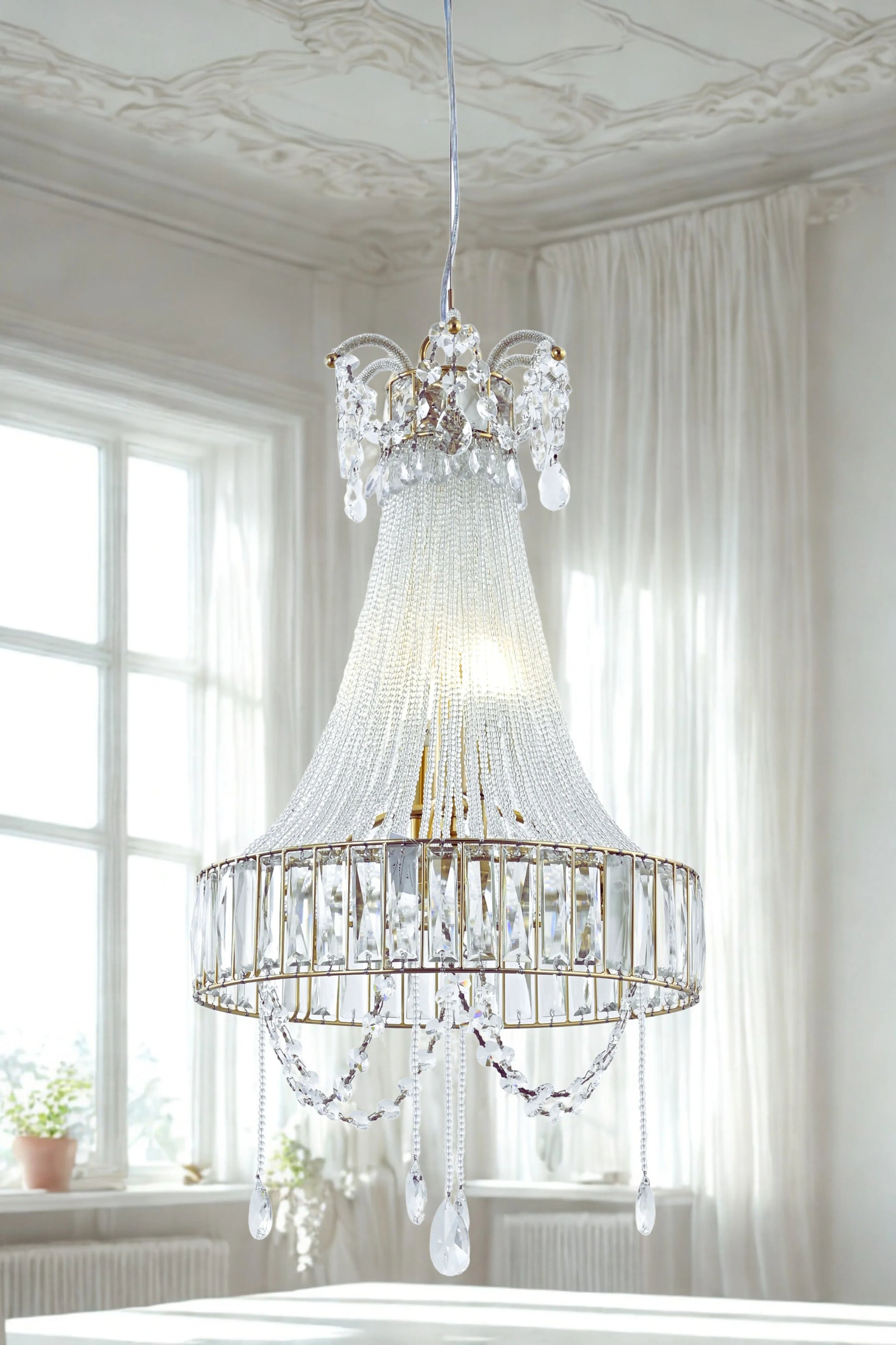 A luxurious crystal glass chandelier with a fluted glass body and hanging crystal beads, displayed in a bright room setting.